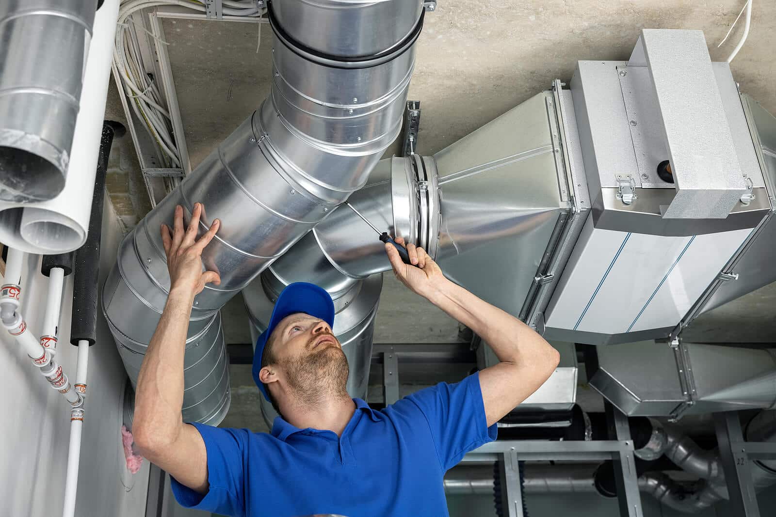 HVAC technician inspecting and repairing air ducts in Glendale