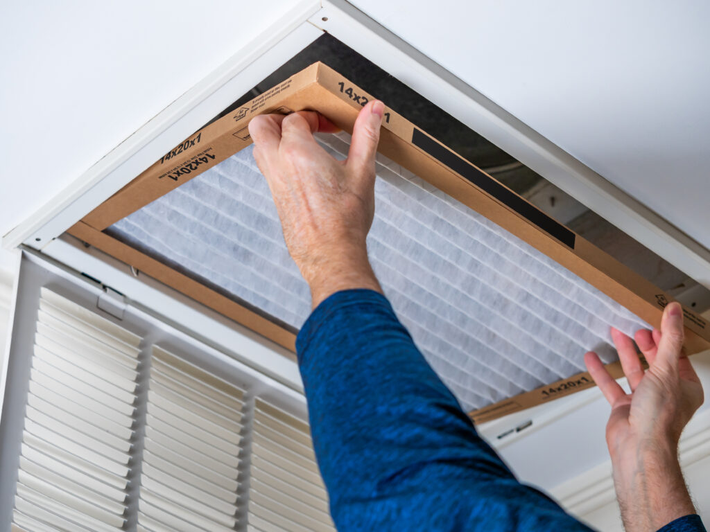 HVAC technician replacing a home air filter in Glendale