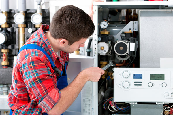 Heating technician repairing boiler controls in Glendale
