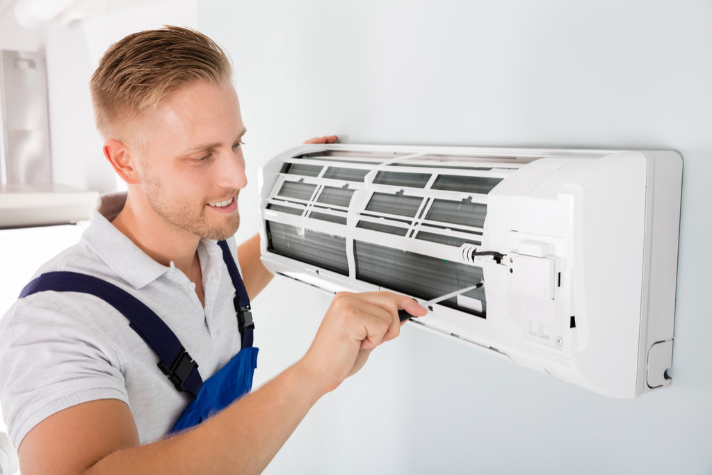 HVAC technician maintaining a ductless air conditioner in Glendale