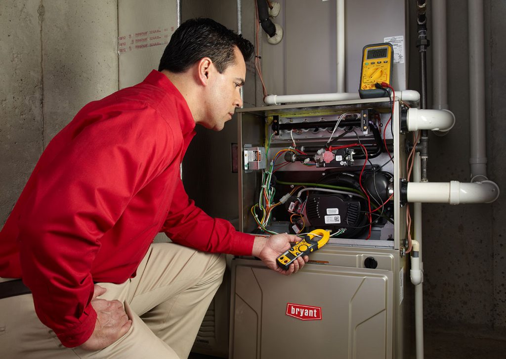 Heating technician diagnosing a furnace repair in Glendale