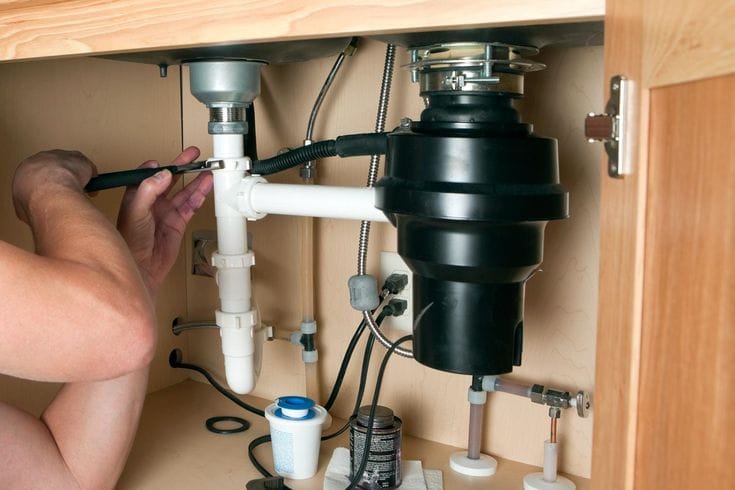 Plumber repairing a garbage disposal in Glendale