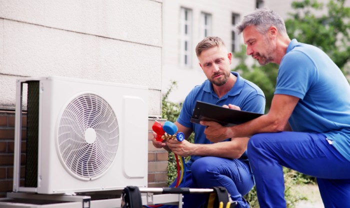 HVAC technicians installing an outdoor air conditioning unit in Glendale