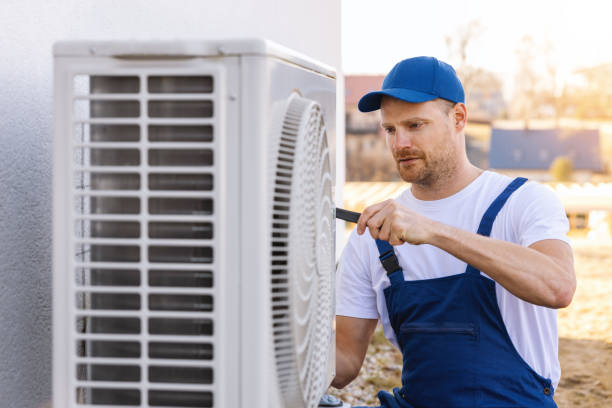 HVAC technician servicing an outdoor air conditioner in Glendale